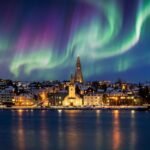 reykjavik iceland skyline with northern lights, colorful aurora over city, reykjavik iceland attractions