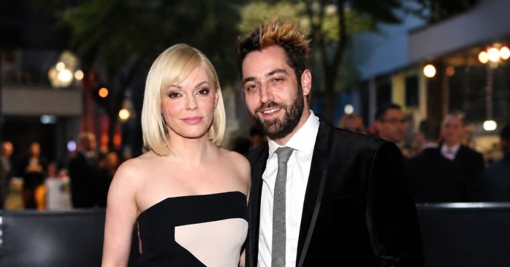 Rose McGowan and Davey Detail at an elegant red carpet event with a cinematic evening background, stylish celebrity couple portrait in high-resolution.