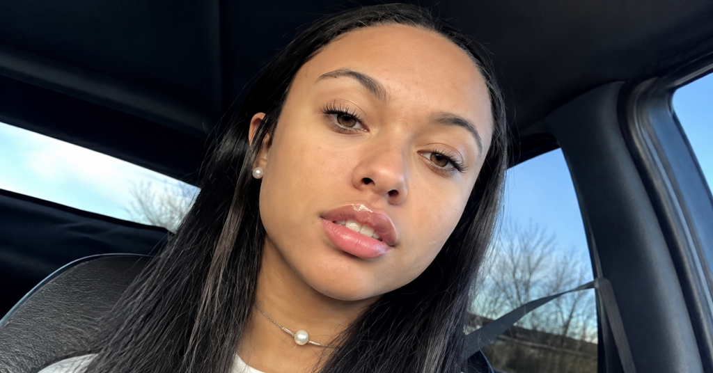 High-resolution portrait of Angelnae sitting inside a car, wearing pearl jewelry and natural makeup, with long dark hair and soft daylight creating a clean, modern lifestyle aesthetic.