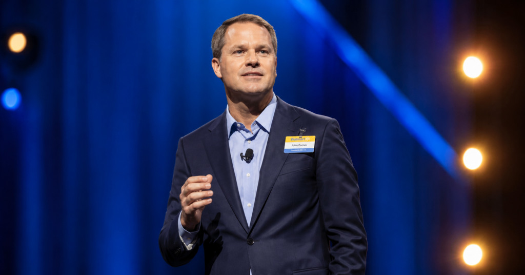 Diane von Furstenberg and Doug McMillon speaking at a business event, featuring Diane von Furstenberg and Doug McMillon in a professional conference setting.