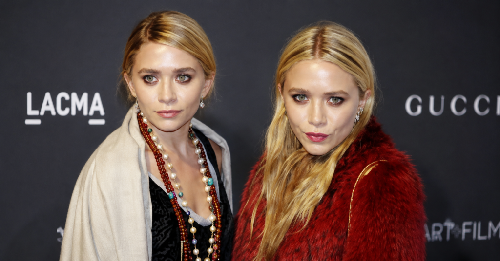 Mary Kate and Ashley Olsen posing together at a red carpet event, featuring Mary-Kate and Ashley Olsen in stylish designer outfits with elegant accessories.