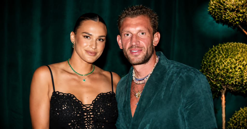Aryna Sabalenka posing with her boyfriend at an event in an elegant evening setting.