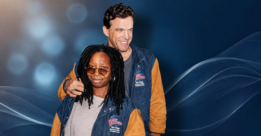 Lyle Trachtenberg standing beside Whoopi Goldberg at a Planet Hollywood event, smiling for photographers in matching denim and tan jackets.